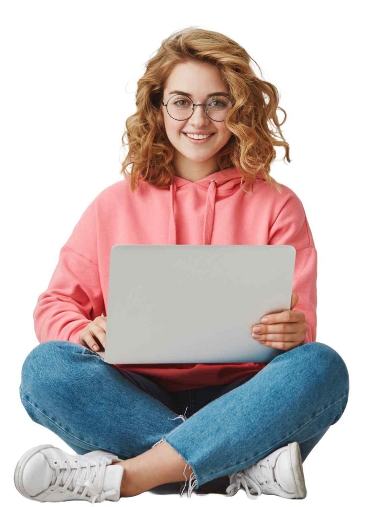 A Woman In Pink Hoodie And Jeans Sitting Cross-Legged With a Laptop learning about us, 27digi as a digital marketing agency