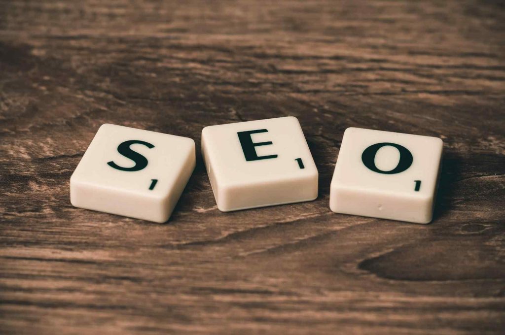 Alphabet Tiles Spelling seo On a Wooden Surface