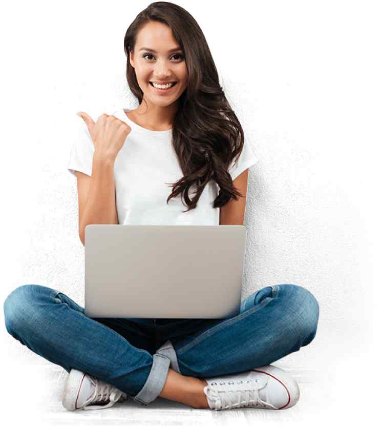 A Woman In White Tee And Jeans Sitting Cross-Legged With a Laptop