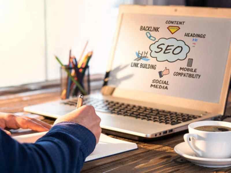 Image 9 Person Working On SEO Strategy With a Laptop Displaying SEO-Related Concepts
